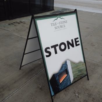 Outdoor sandwich board sign advertising a business entrance in Edmonton