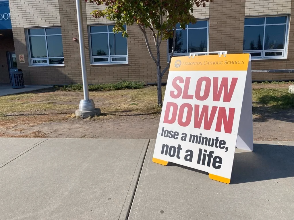 Sandwich board signs displaying business promotions outside a storefront in Edmonton